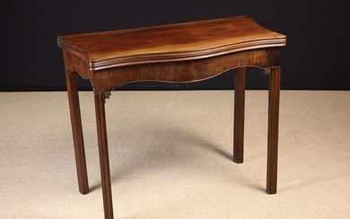 A George III Mahogany Serpentine Flip-top Card Table, with green baize playing surface. Standing on
