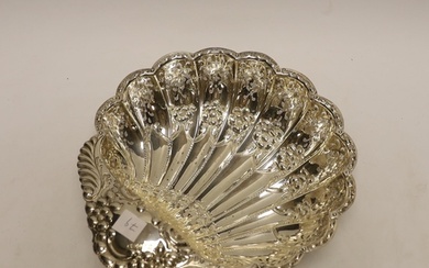A George V pierced silver scallop shaped bowl, on fluted bal...