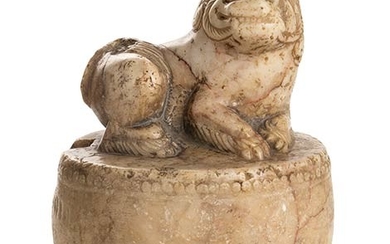 A MARBLE BUDDHIST LION ON A ROUND DRUM China, early...