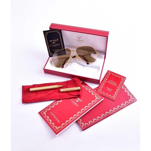 A Must de Cartier gilt metal pen, in original box, together ...