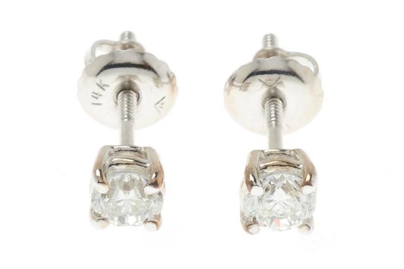 A PAIR OF 18CT WHITE GOLD SOLITAIRE DIAMOND STUD EARRINGS; each set with a round brilliant cut diamond of 0.25ct G/SI, on threaded p..