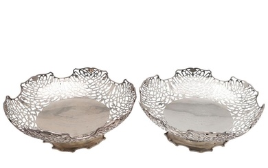 A PAIR OF MID-20TH CENTURY PIERCED SILVER DISHES. shaped cir...