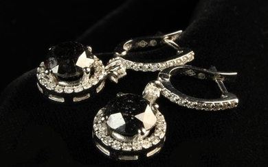 A Pair of Fancy Black Diamond Drop Earrings. The round cut black stones totalling 2.66 carat weight