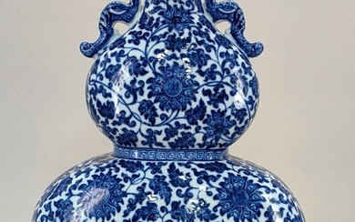 A Qing Dynasty Qianlong-style blue and white double-handled flat gourd vase