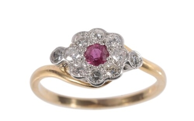 A RUBY AND DIAMOND DAISY CLUSTER RING the round-cut ruby and...