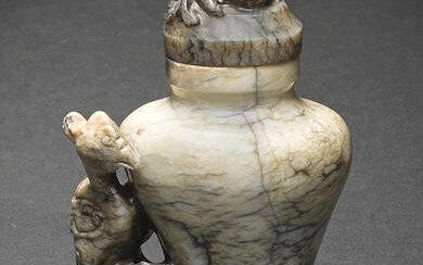 A SMALL CREAM AND BLACK JADE 'PHOENIX' VASE AND COVER