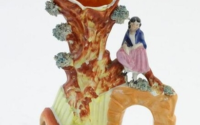 A Staffordshire pottery flat back bud vase depicting a