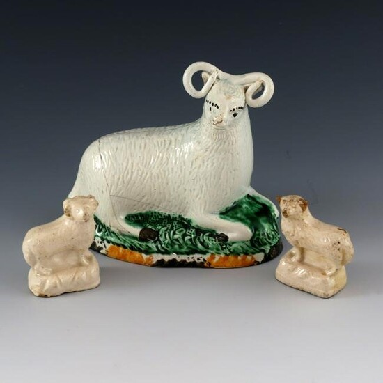A Staffordshire pottery ram and two whit