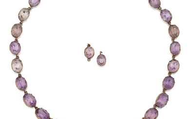 A Victorian gold mounted amethyst necklace, composed of a single row of cushion and oval cut amethysts to an earlier amethyst drop in chased oval mount, with later bolt clasp, approx. length 38cm