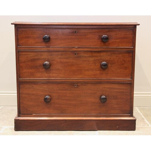 A Victorian mahogany chest of drawers, formed as three cock ...