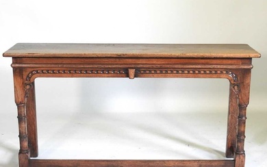 A carved oak console table, 20th century, on turned legs,...