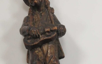 A carved oak figure of a hurdy-gurdy player, 19th century, 20cm high