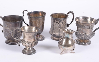 A collection of silver beakers