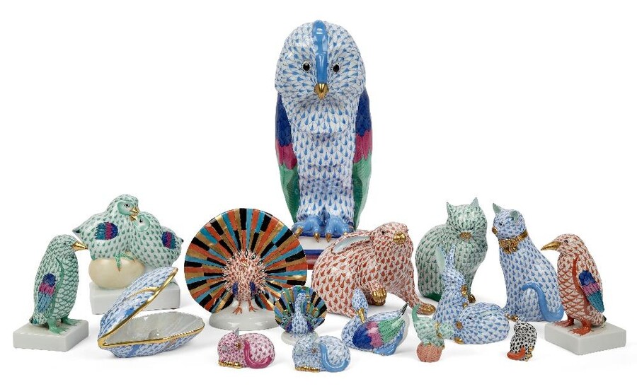 A collection of sixteen Herend porcelain figures, late 20th/21st century, printed blue marks to underside, decorated in scale pattern in various colour ways, to include a large figure of an owl standing on a pile of books, 28.5cm high; a peacock in...