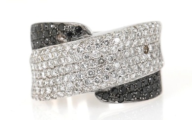 A diamond ring set with numerous brilliant-cut black and white diamonds, mounted...