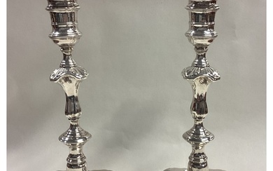A fine pair of George II cast silver candlesticks. London 17...