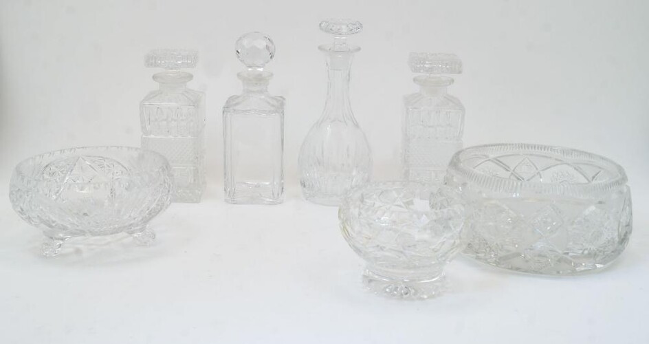 A group of cut glass bowls and decanters, 20th century, to include: a bulb shaped decanter with elongated neck and flat base, with stopper, 27cm high; two rectangular decanters with diamond moulded band to the body and rectangular stoppers, 22cm...