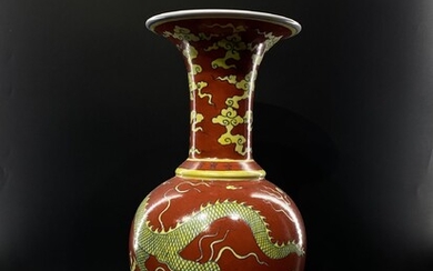 A large Chinese trumpet shape porcelain vase with red...