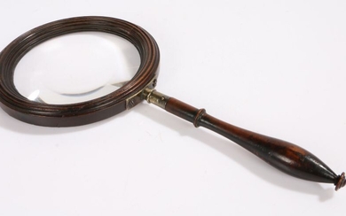 A large George III fruitwood hand-held magnifying glass, circa 1800, the circular glass within a
