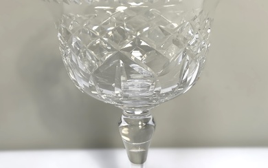 A large selection of clear crystal table glassware, including various sets of wine goblets, brandy