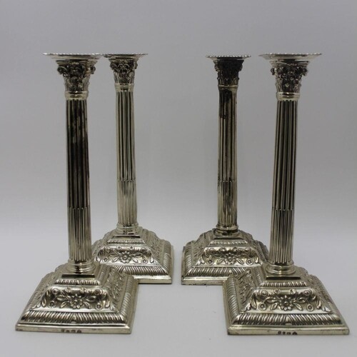 A matched set of four silver candlesticks, Corinthian column...