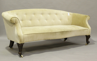 A mid-Victorian tub back settee, upholstered in buttoned velour, raised on cabriole legs and castors