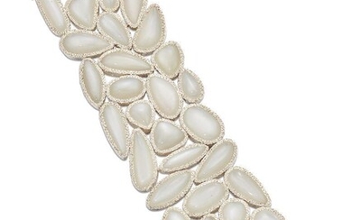 A moonstone bracelet, of broad, flexible design composed of a series of vari-shaped cabochon moonstones, length 21.0cm