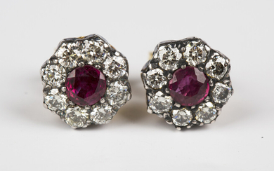 A pair of 18ct gold, ruby and diamond earstuds, each claw set with a circular cut ruby within a surr
