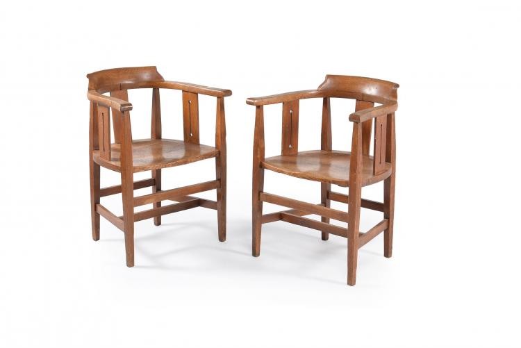 A pair of Arts and Crafts oak smokers bow armchairs