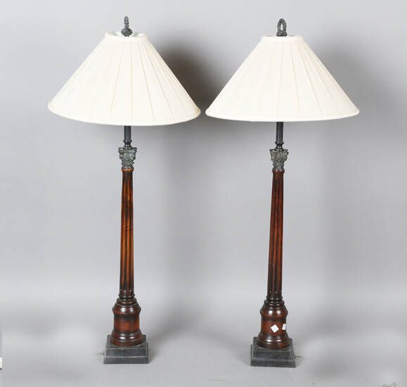 A pair of Georgian style mahogany table lamps by Theodore Alexander, the tapering fluted stems with