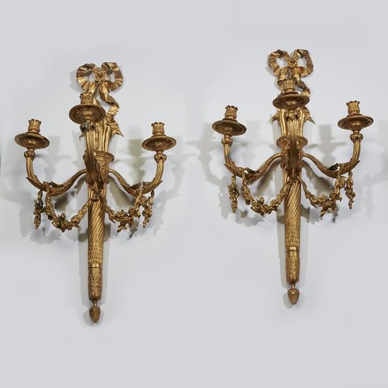 A pair of Louis XVI style gilt-bronze three-light