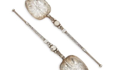 A pair of Victorian silver replica anointing spoons, London, c.1886, Francis Higgins III, both designed with stylised zoomorphic headed stems, the bowls chased with scroll and foliate motifs, 26.2cm long, total weight approx. 6.7oz (2)