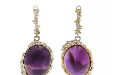 A pair of amethyst ear pendants each set with a cabochon amethyst, mounted in rhodum plated and partly gilded sterling silver. W. 18 mm. L. 42 mm. (2)