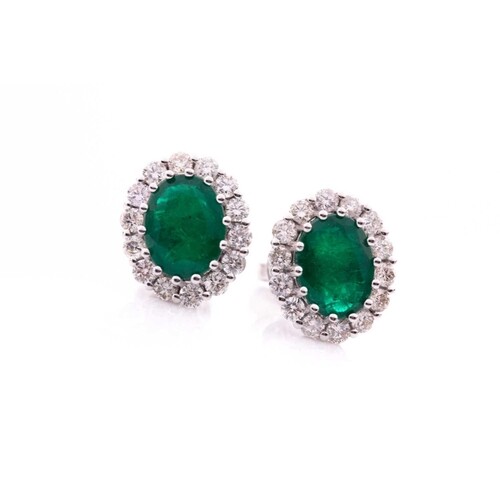A pair of diamond and emerald cluster earrings, each set wit...