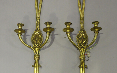 A pair of early 20th century Neoclassical Revival gilt bronze twin-branch wall lights, the backplate