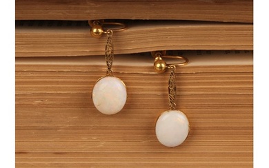 A pair of opal drop earrings, each with a single oval polish...