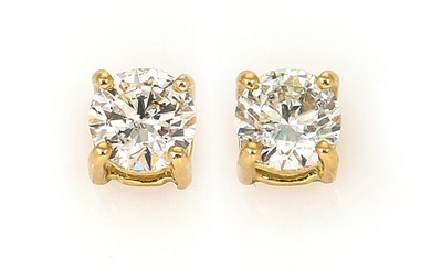 A pair of solitaire diamond ear studs each set with a brilliant-cut...
