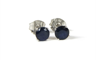A pair of white gold single stone sapphire stud earrings