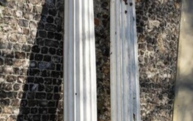 A pair of white painted fibreglass models of fluted columns