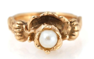 A pearl ring set with a cultured pearl and decoraited with a...