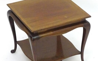 A small early 20thC mahogany table with a crossbanded
