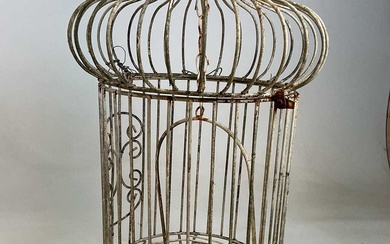 A vintage wrought iron onion topped birdcage.A vintage wrought iron...
