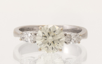 An 18K white gold ring set with one round brilliant-cut diamond and two marquise-cut diamonds