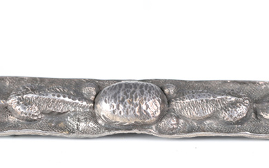 An Arts and Crafts silver rectangular bar brooch, decorated in relief and hammered with stylized fol
