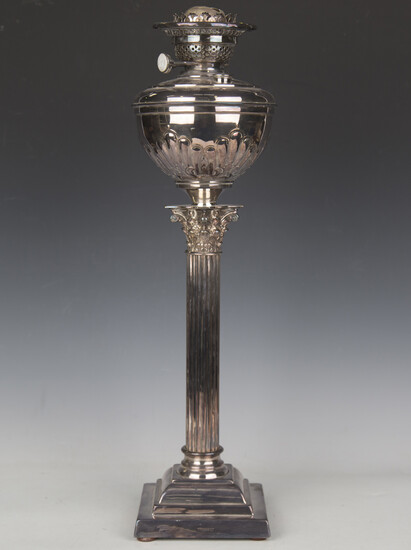 An Edwardian plated Corinthian column table oil lamp with Duplex winders, height 58cm, together with
