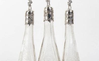 An Italian silver 800/1000 and cut glass three bottle...
