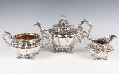 An early Victorian silver harlequin three-piece tea set of lobed melon form on stylized scallop shel
