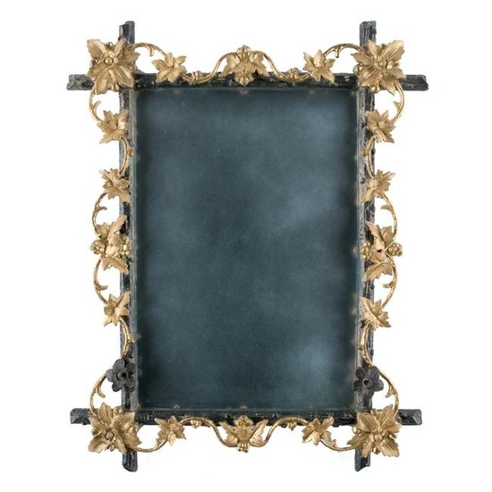 An ebonized and gilt wood wall mirror