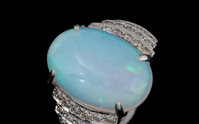 An opal ring set with a cabochon opal weighing app. 5.15 ct....