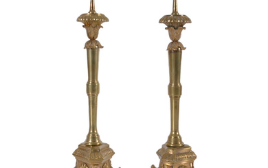 A pair of burnt-gilt bronze candlesticks, a work of Paris, Louis XVI, 18th century.